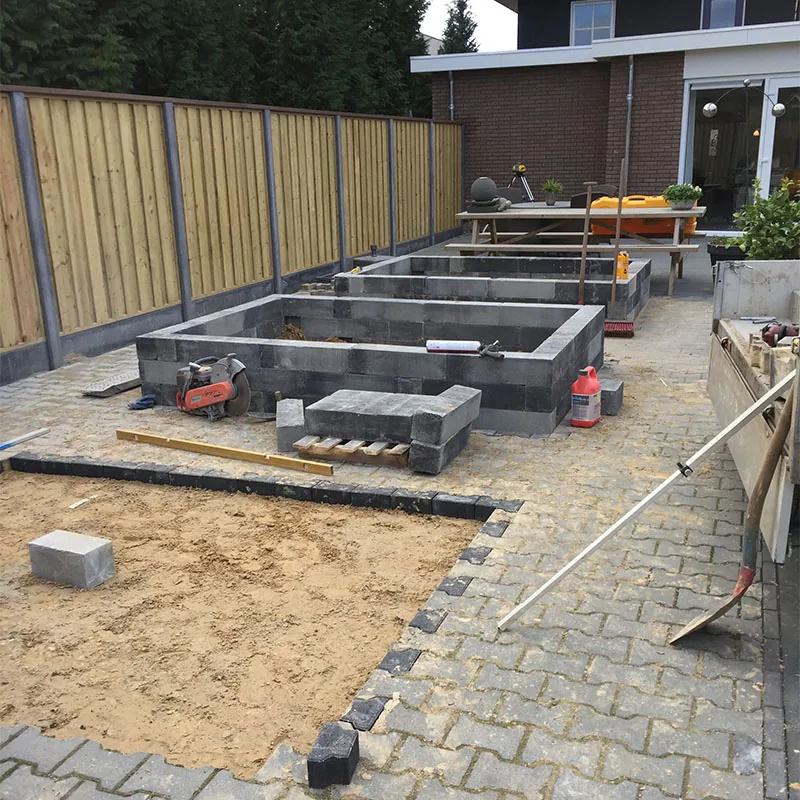 Aanleg van verhoogde bloembakken in een particuliere tuin